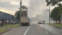 Woman on her way to work drives past busted pipe spouting water like a fountain