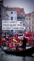 Santa Clauses spread holiday cheer on Venice's Grand Canal