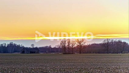 Scenic View On The Countryside With Fiery And Vibrant Sun Setting On The Horizon Until Calm Sunrise