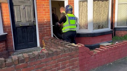 Police break down door and discover secret cannabis farm hidden behind fake walls and loft hatch