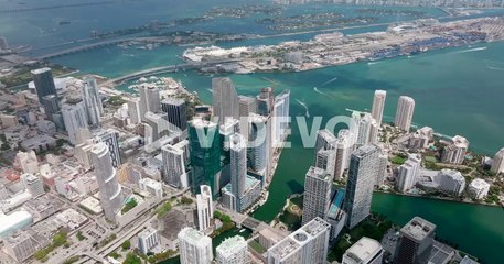 Aerial panoramic shot of downtown skyscrapers at Miami river estuary