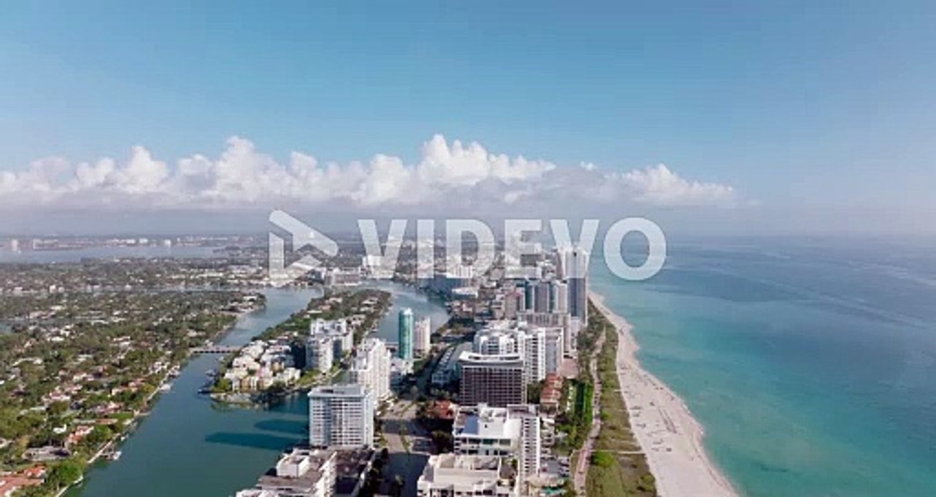 Aerial panoramic footage of tall modern buildings in urban borough on sea coast