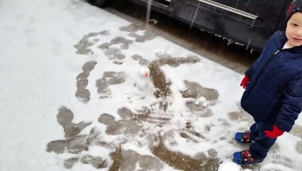 Little Boy Slips and Falls While Kicking Tiny Snowman