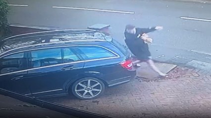 Man falls but quickly gets up and collects his items in a hurry