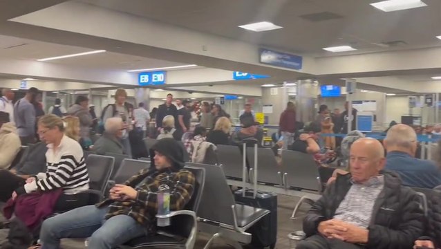 Watch: Passengers stranded on Christmas Eve as American Airlines grounds all flights