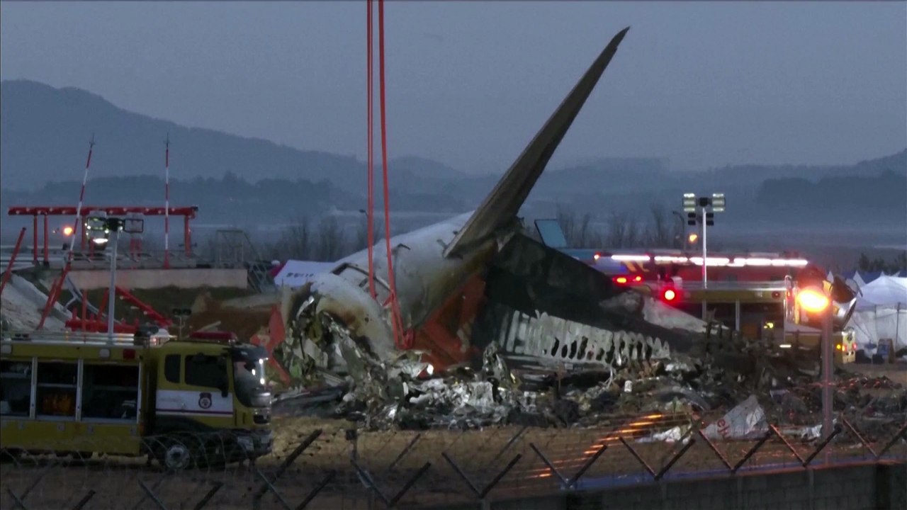 Workers search Jeju Air crash wreckage on the morning after