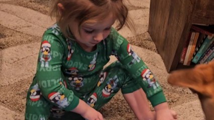 Grinch blanket leaves girl in awe as she unwraps her Christmas present