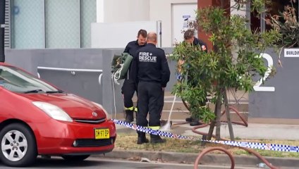 Police questioning a man after a woman falls from a balcony