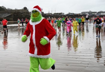 Fancy dress dippers dash for the sea at Saundersfoot New Year's Day Swim