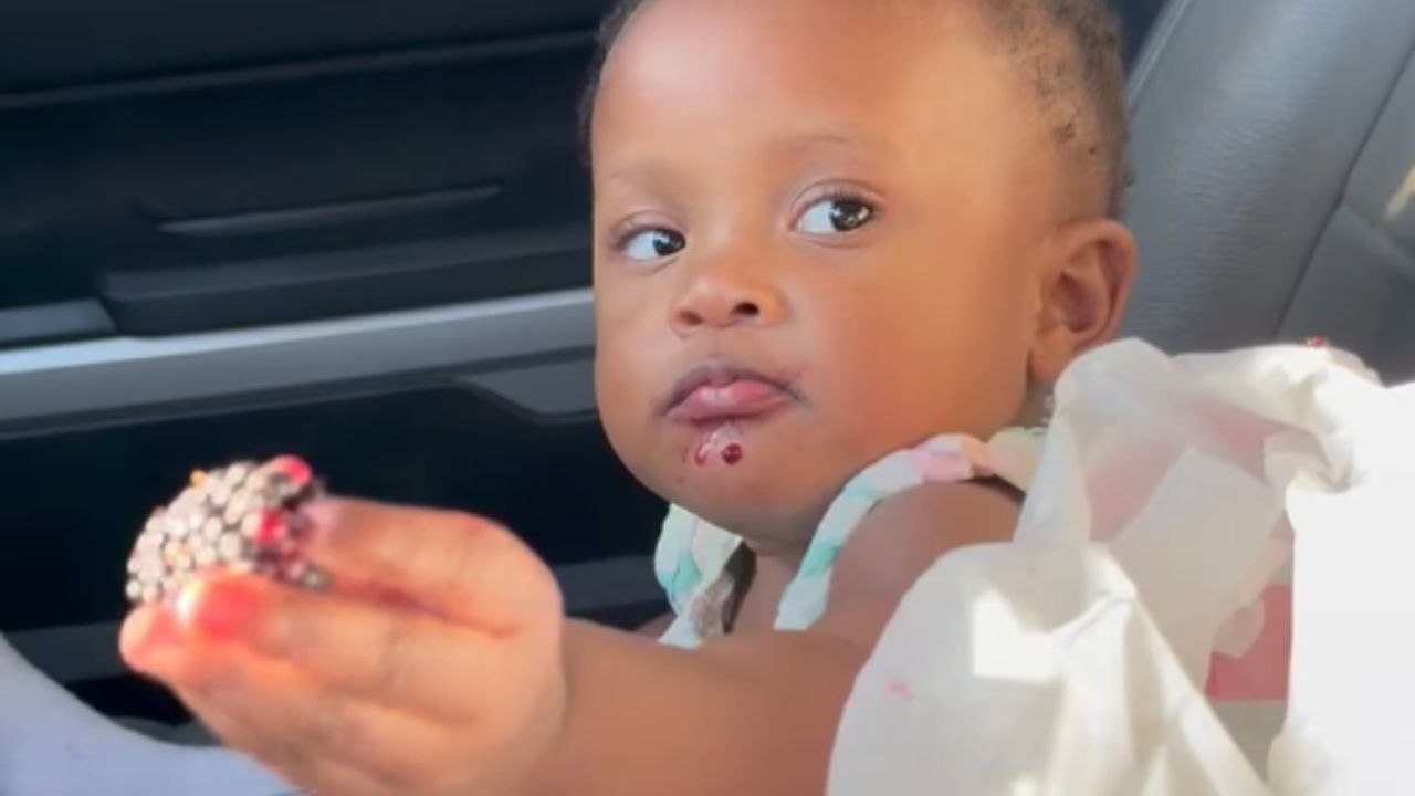 Annoyed baby girl redirects mom’s attention from berries to water