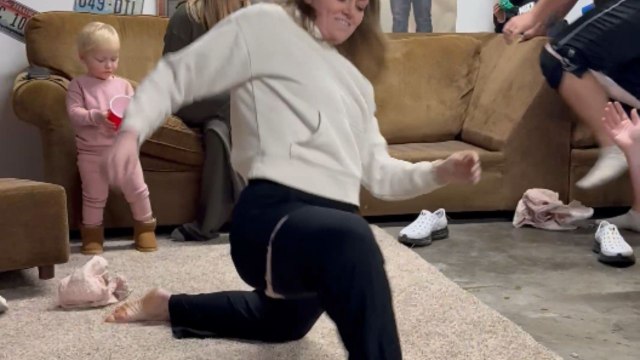 Family plays a hilarious Christmas game of putting on diapers without hands