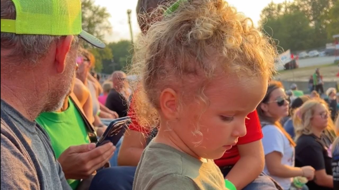 Sweet moment as uncle covers niece’s ears during noisy truck and tractor pulls at county fair