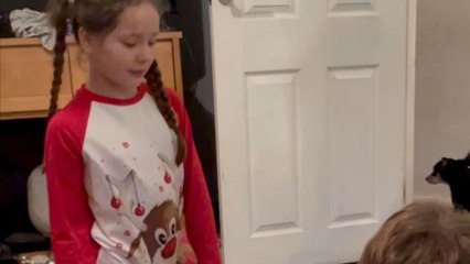 Santa leaves hidden Christmas presents behind the door for kids