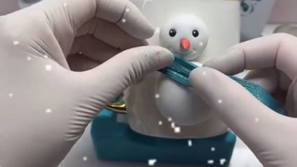 Polymer clay artist adds charm to a simple mug by adorning it with lovely snowman artwork