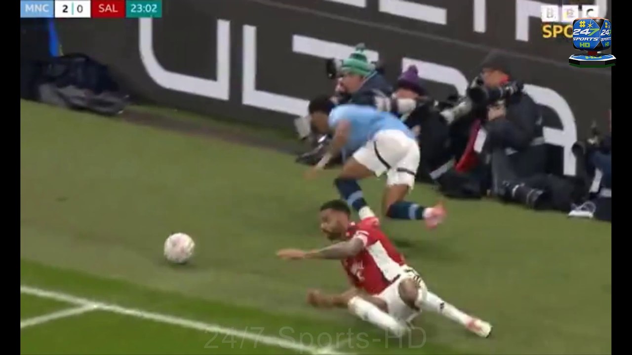 Shocking Moment: Savinho Narrowly avoids injury after Falling Off the Pitch Photographers Collision