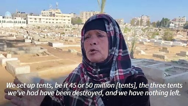 Displaced Palestinians set up tents in central Gaza cemetery