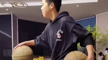 Boy shows off basketball dribbling skills while perched on bench