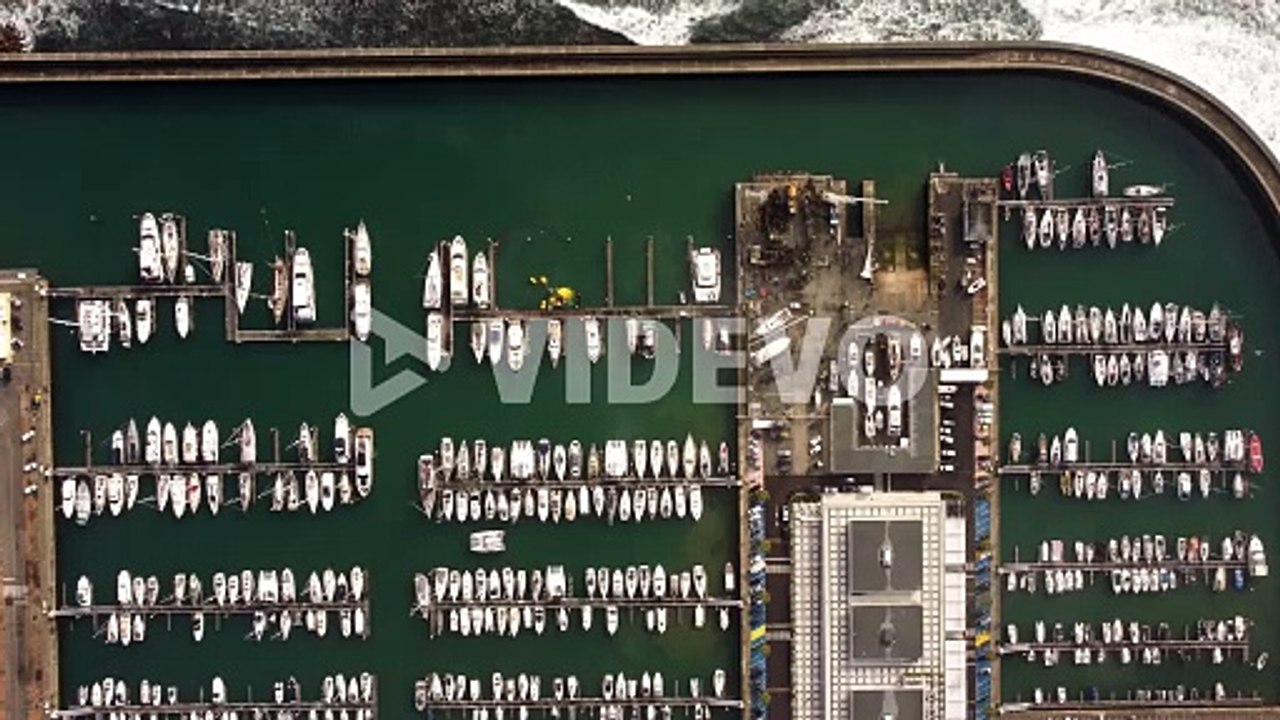 Aerial minimalist top down view of luxury yacht sail fisherman boat moored at port