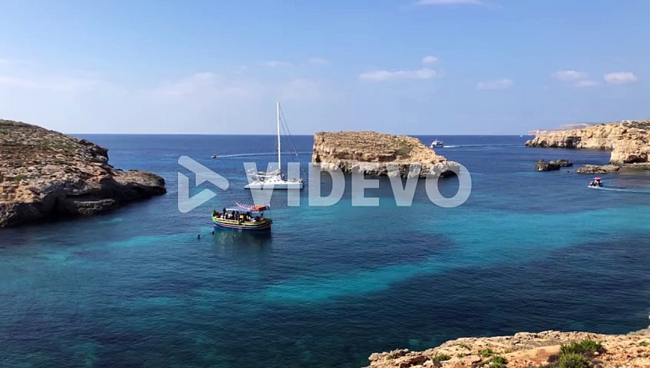 static shot of luxury sail boat yacht moored in pristine clear ocean sea paradise