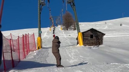 Thrill-seeker's attempt on the T-bar lift ends in a snowboarding mishap