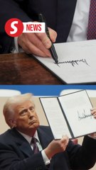 Trump signs first executive orders in front of a cheering crowd