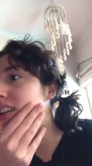 Table Glass Shatters in Background as  Woman Films Selfie Video