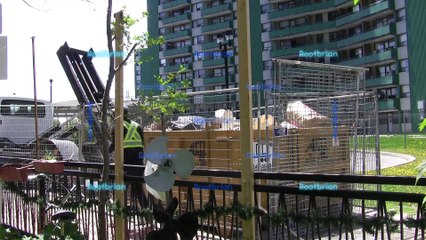 A truck hauls away a large 5 metre steel bin