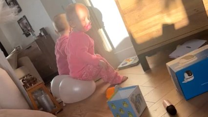 19-month-old laughs at herself in the mirror before balloon pops