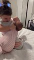 Toddler Playfully Imitates Nursing Her Baby Sibling