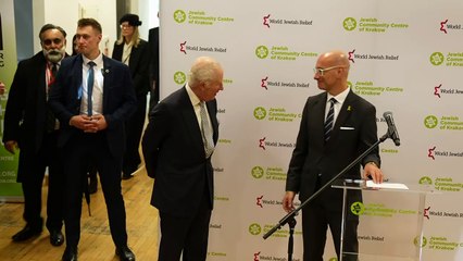 King marks 'sombre and sacred moment' in Krakow