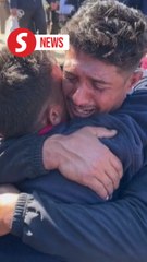 Palestinian twins share emotional embrace after a year apart
