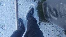 Confident attempt at running on ice ends in a hilarious slip and fall