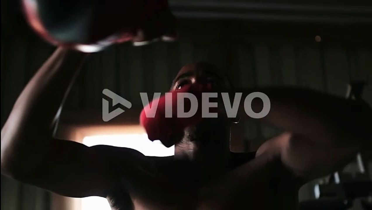 African American male boxer practicing boxing in fitness studio 4k