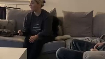 Dog becomes completely engrossed in opera music playing on the TV