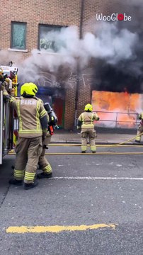 Nearly six dozen firefighters battle the intense fire wrecking building in Kilburn