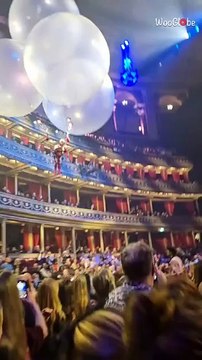 Cirque du Soleil performer floats with balloons in Corteo launch act