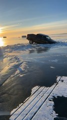 Pickup Truck Gets Stuck in Frozen Lake After Hitting Ice Heave