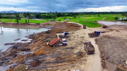 Nice Processing Dump Truck Transports Dust Into Deeply Large Pond and Bulldozer Push Stone