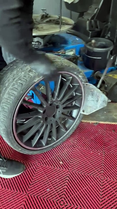 Tire Rim Breaks While Person Tries to Disassemble it