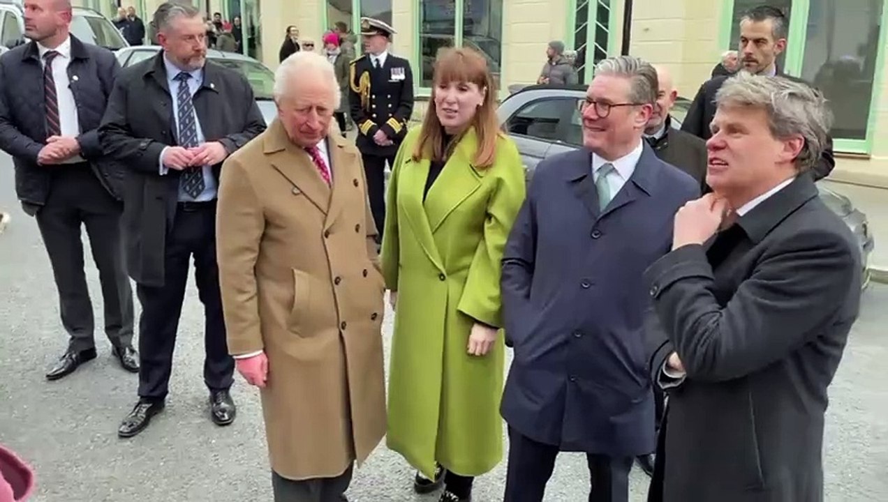 Ben Murphy from the Duchy of Cornwall joking with a shop owner during a visit by the King and the Prime Minister to Nansledan