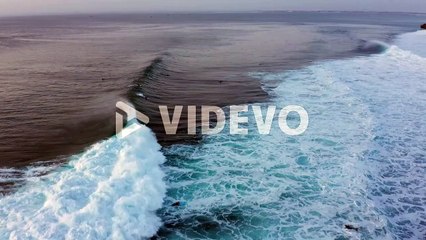 Waves and Surfers on Bali Island South Coast on Indian Ocean, Cinematic Twilight Aerial