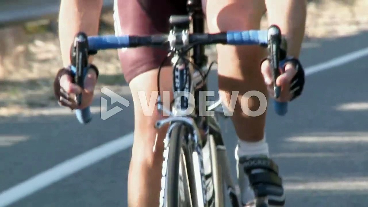 A bicyclist rides down a highway