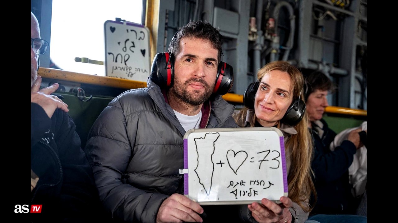 Released hostage Sagui Dekel Chen embraces his wife and reunites with sisters