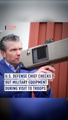 U.S. defense chief checks out military equipment during visit to troops