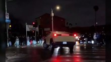A cybertruck attempts to do donuts during a street takeover
