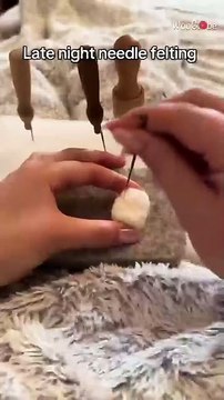 Artist makes a wool cow car freshener with needle felting