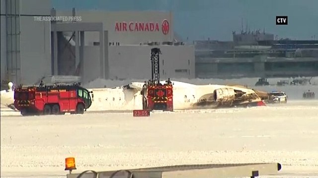 Delta Airlines plane flips on landing in Toronto and a badly hurt child is among 8 casualties
