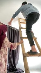 Man Falls from Ladder While Hanging Curtain