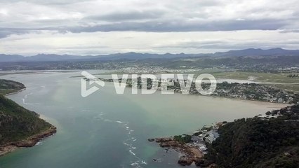 Knysna Lagoon, quiet Leisure Isle and surrounding green hills, aerial