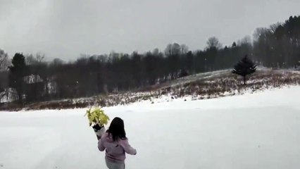 Person Falls in Snow While Carrying Flowers in USA